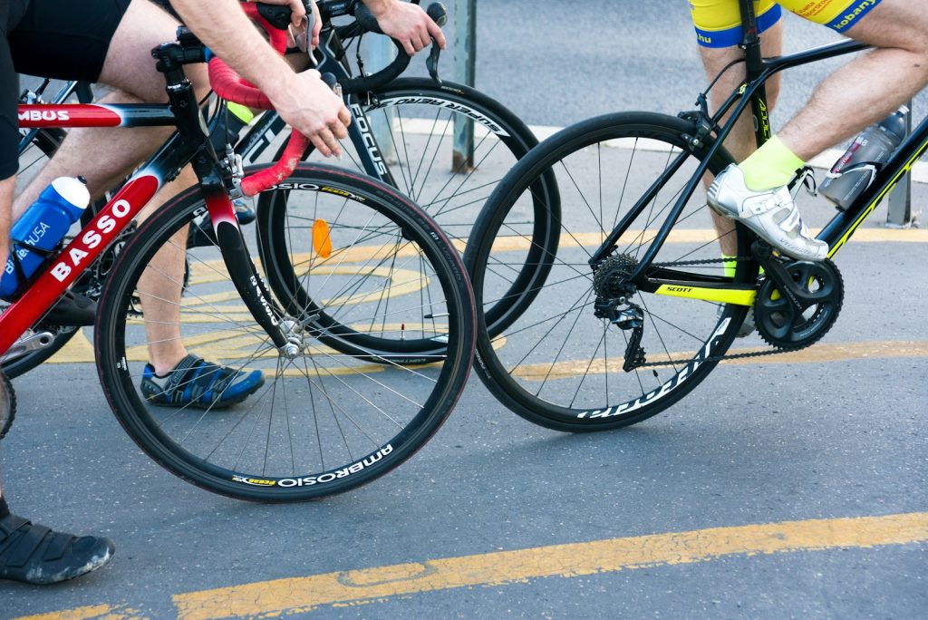 person in black and green bicycle helmet riding on black bicycle during daytime