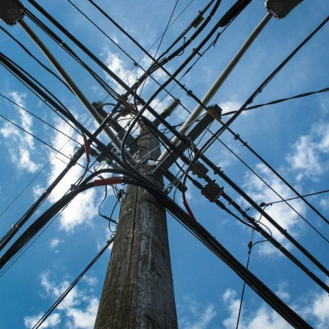 low angle photo of electric post with cables