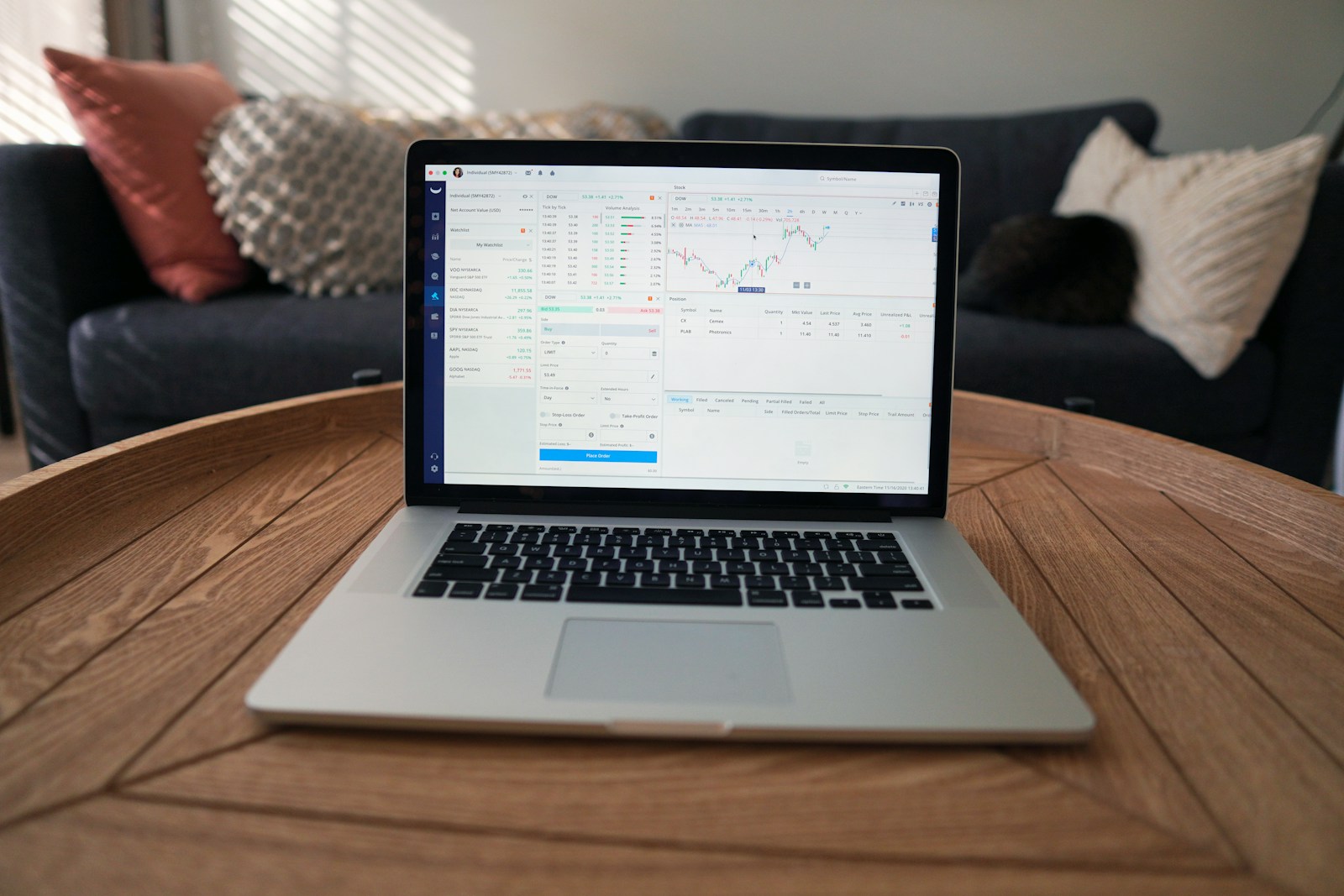 macbook pro on brown wooden table