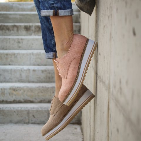 person wearing brown loafers
