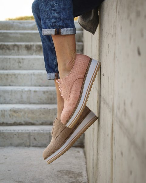 person wearing brown loafers