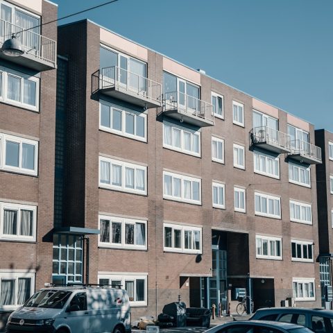 a large brick building with many windows and balconies