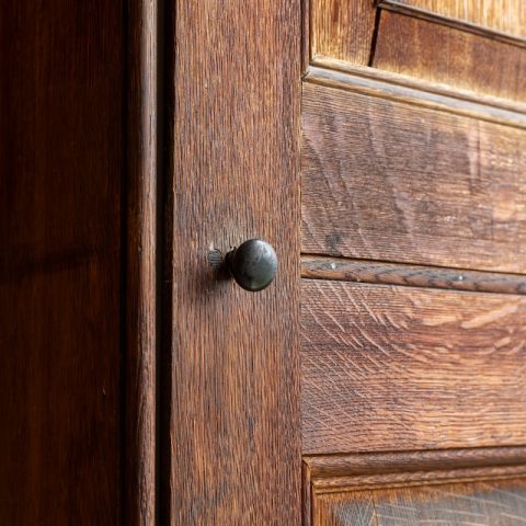 a close up of a door handle on a wooden door