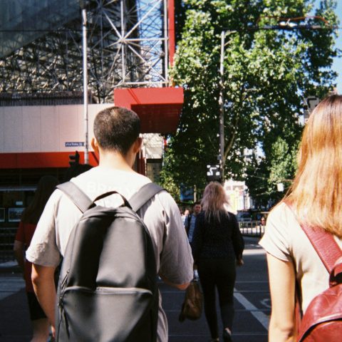man in white shirt standing beside woman in pink shirt