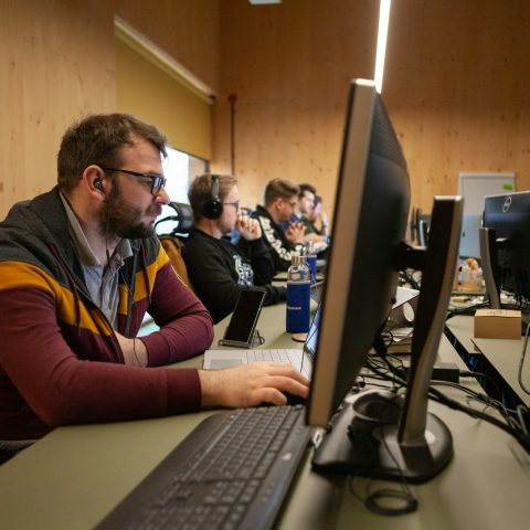 a man sitting in front of a computer on a desk