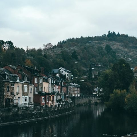 canal houses near mountain during daytime