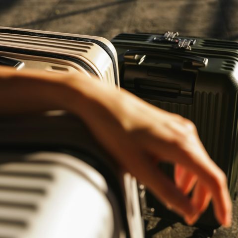 a hand is reaching for a piece of luggage