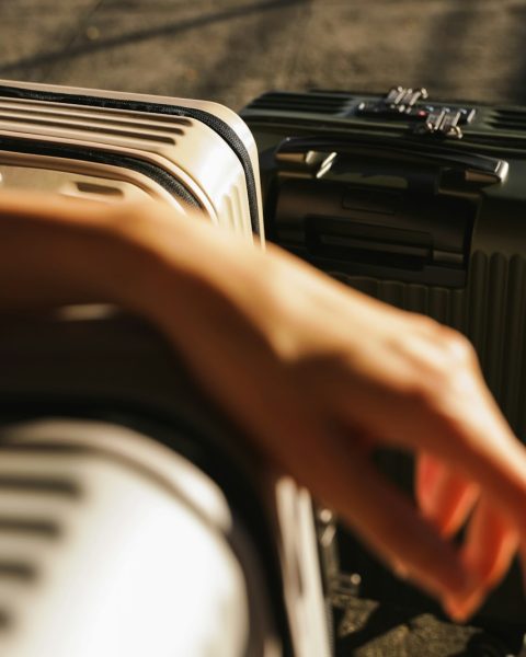 a hand is reaching for a piece of luggage