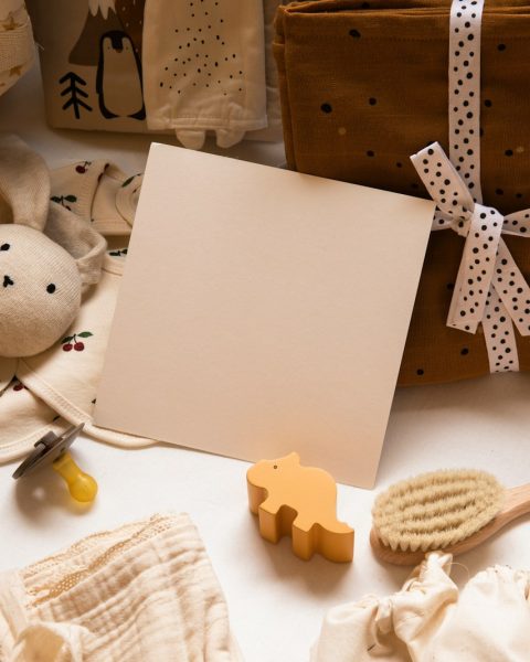 white printer paper beside brown bear plush toy