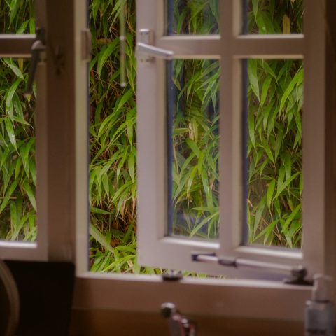 a kitchen sink sitting under a window next to a sink