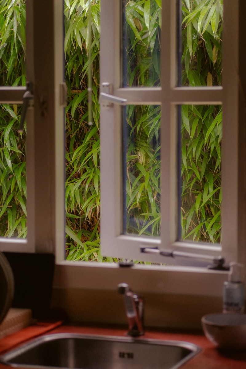 a kitchen sink sitting under a window next to a sink