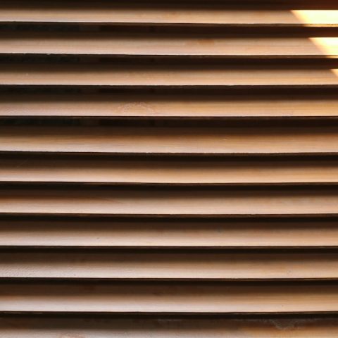 A close up of a window with blinds on it