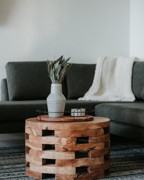 white and black ceramic mug on brown wooden table