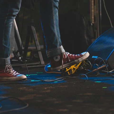a person standing on top of a stage next to a microphone