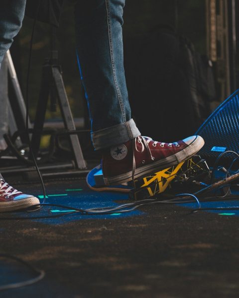 a person standing on top of a stage next to a microphone