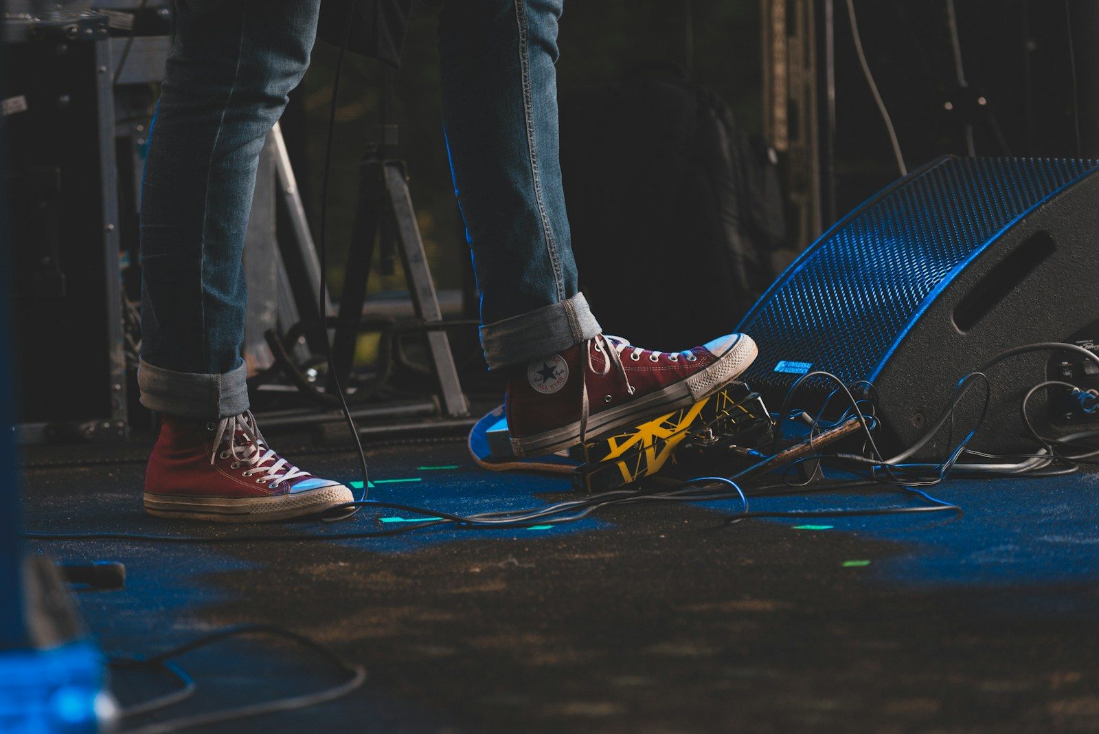 a person standing on top of a stage next to a microphone