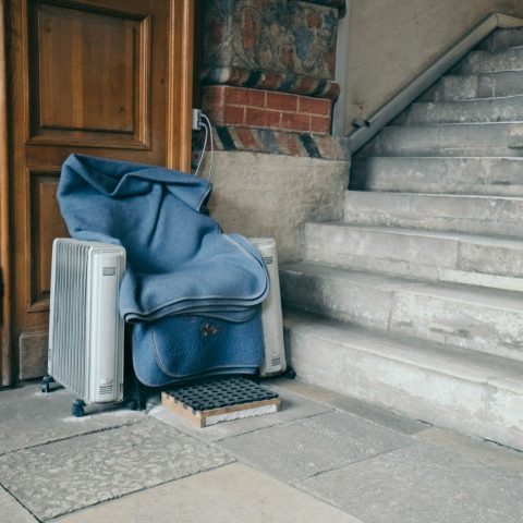 blue and black backpack on gray concrete stairs