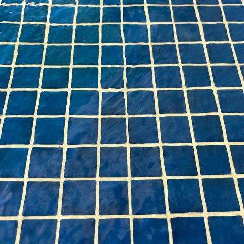 a close up of a blue and white tiled floor