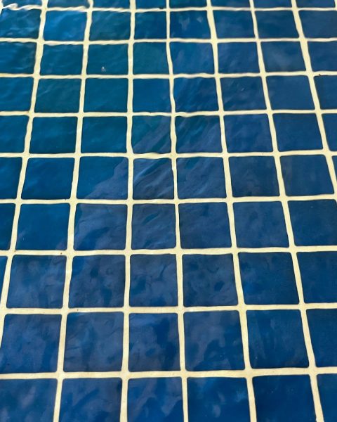 a close up of a blue and white tiled floor