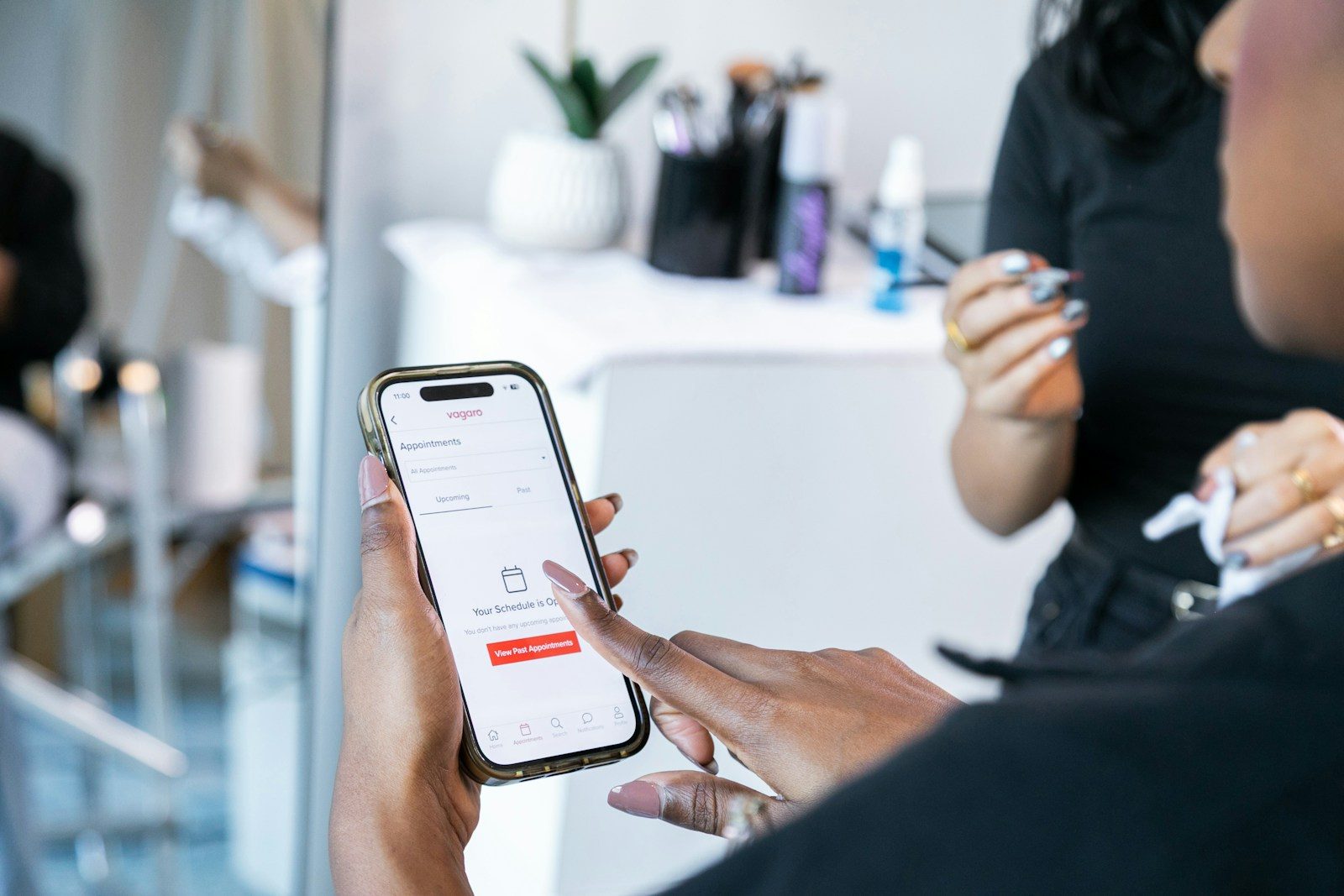 Hands holding a smartphone displaying a booking app.